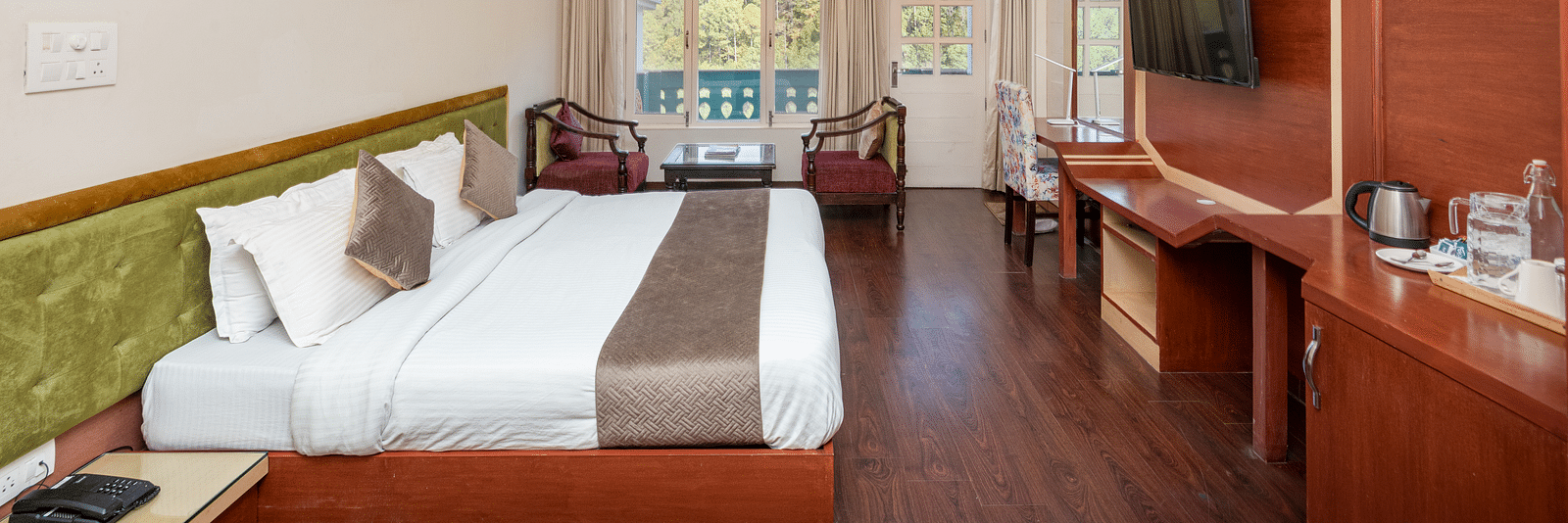 Image of a room at DLS Tehri Club Resort offering a relaxing space with a comfortable bed and seating.